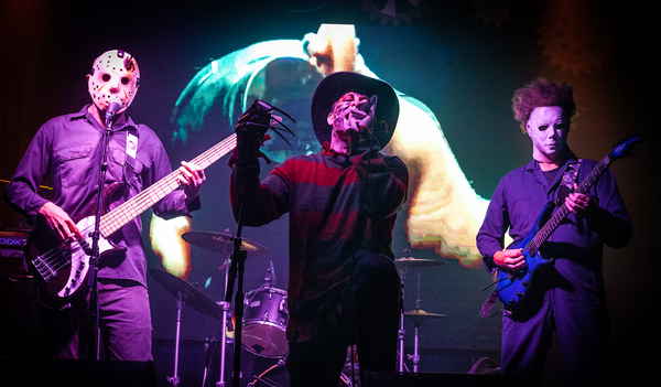 Professional picture of three horror movie themed characters while passionately performing onstage together | Altus Entertainment